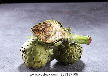 Artichokes On Rustic Background. Fresh Organic Artichoke Flower Set