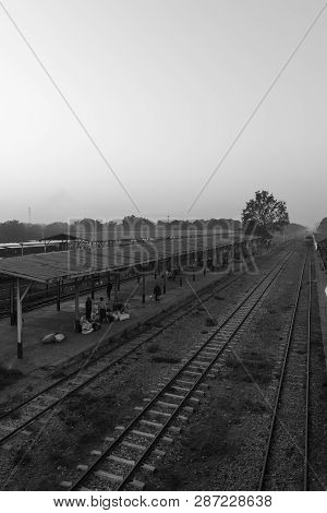 Thazi, Myanmar - 23 November, 2018: Black And White Picture Of People Walking On The Rails At Thazi 