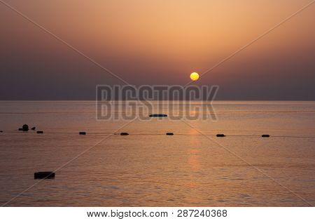 Sunrise Over The Sea By The Shore With Rocks In The Morning Sun.