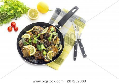Fish Dishes. Fresh, Hot, Fried Cod Fish With Onions In A Frying Pan Close-up On White Background