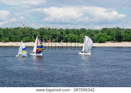 Regatta Competition On Lake River Sailing Yachts Boats With White Sails And Gennakers, Reflected Sky