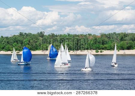 Regatta Competition On Lake River Sailing Yachts Boats With White Sails And Gennakers, Reflected Sky