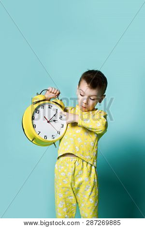 Cute Little Boy With Alarm Clock,isolated On Blue. Funny Kid Shouting Joyfully Pointing At Alarm Clo