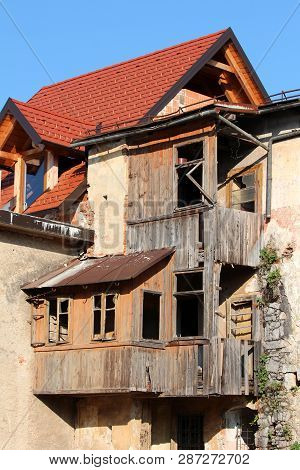 New Roof Tiles On Top Of Brand New Red Bricks House With Old Abandoned Wooden Broken Multi Level Hou