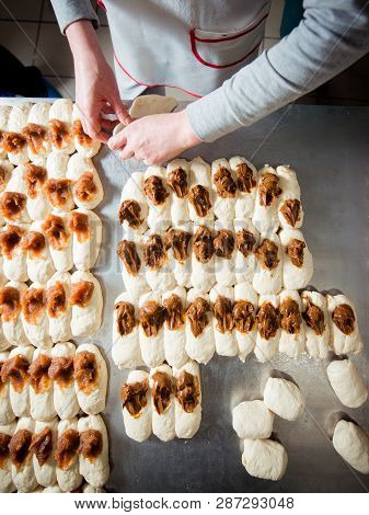 Baker Make Buns With Filling Of Jam And Condensed Milk  From Dough