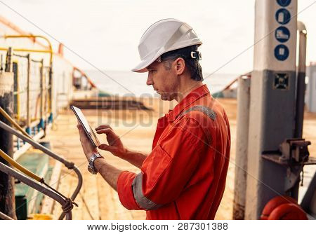 Chief Officer Or Captain On Deck Of Vessel Or Ship Watching Digital Tablet