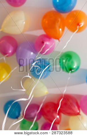Colorful Balloons Under The Ceiling. Preparing For A Birthday Party Or Other Holiday. Celebration Co