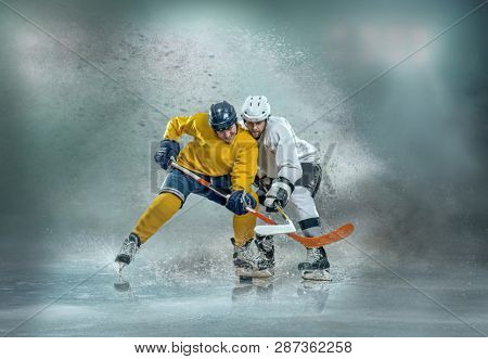 Caucassian ice hockey Players in dynamic action in a professional sport game play on the laptop in hockey under stadium lights.