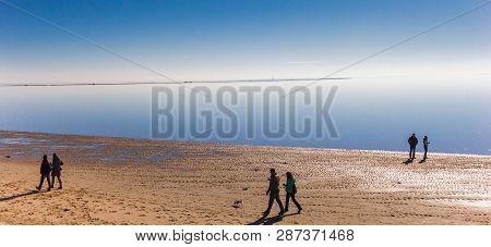 Wilhelmshaven, Germany - February 24, 2019: People Walking At The Beach In Wilhelmshaven, Germany