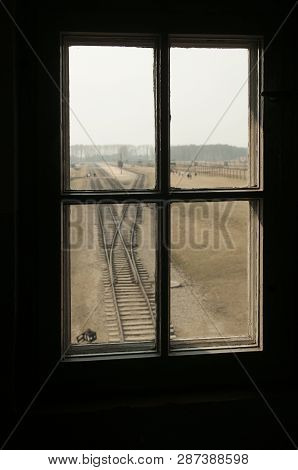 Auschwitz, Poland - March 30 2012 Melancholic View Through A Window Of A Concentration Camp Railway 