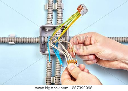 Electrician Connects The Wires Together With Help Of Pluggable Terminal Blocks.
