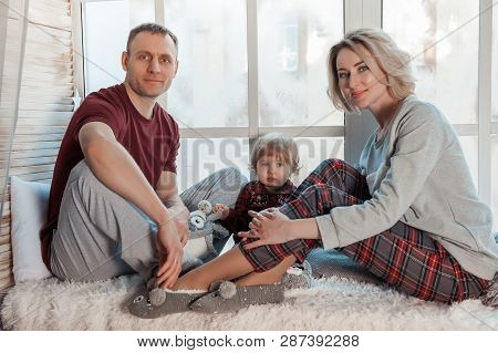 Mother With A Little Daughter. Family In Home Clothes.