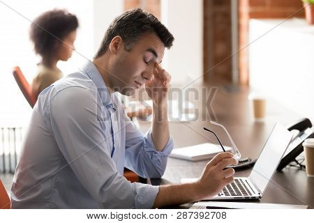 Tired Stressed Middle-aged Businessman Holding Glasses Feel Eyestrain At Work