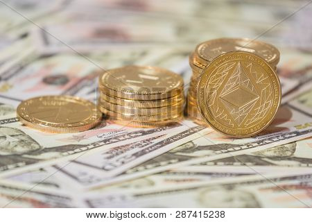 Business Concept Of Crypto Currency. Golden Etherium Coin On Us Dollars Close Up.