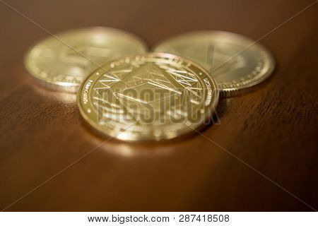 Golden Etherium Coin Close Up. Ether Is A Cryptocurrency Whose Blockchain Is Generated By The Ethere