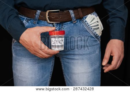 Bank With Semen In The Hand Of A Male Donor And Money Dollars