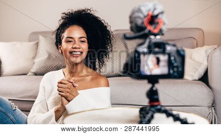 Happy Female Vlogger Live Streaming From Living Room Using Dslr Camera