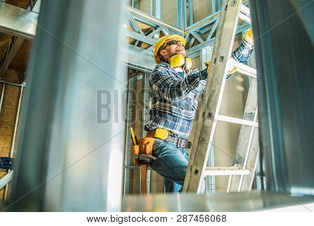Skeleton Steel Building Construction Worker Wearing Safety Hard Hat And Noise Reduction Headphones. 