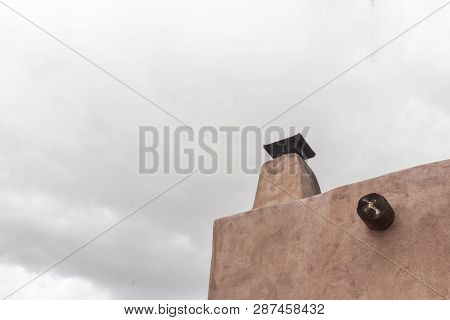 Exterior Of Traditional Adobe Building With Chimney, Viga, Overcast Sky, Copy Space, Horizontal Aspe