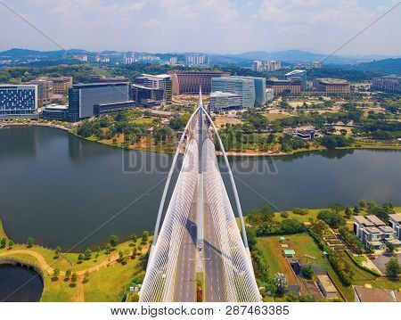 Seri Wawasan Bridge Or Putra Bridge And Putrajaya Lake With Blue Sky. The Most Famous Tourist Attrac