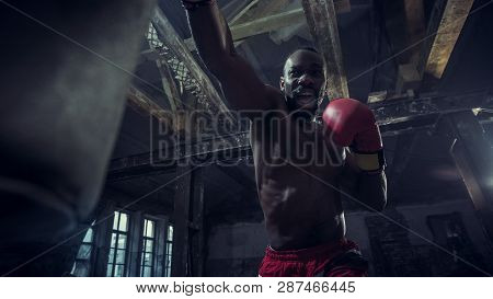 Hands Of Boxer Over Dark Gym Background. Strength, Attack And Motion Concept. Fit African American M