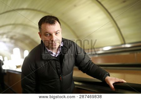 Man Moves On Escalator In Subway