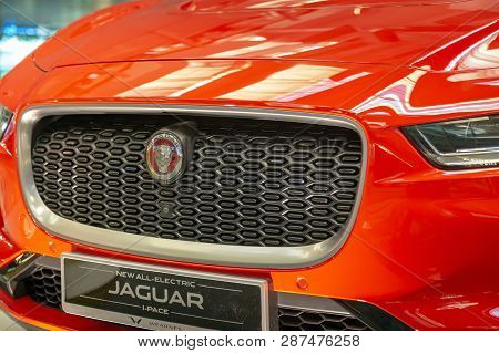 Singapore. March 2019. Orange Jaguar I-pace All Electric Suv. Front View, Led Headlights And Grill W