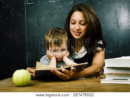Little Cute Boy Pupil With Young Real Teacher, Classroom Studying At Blackboard School Kido, Lifesty