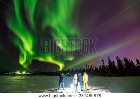 Multicolored Green Violet Vibrant Aurora Borealis Polaris, Northern Lights In Night Sky Over Winter 