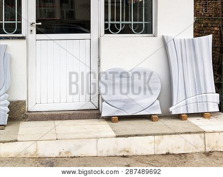 Small Private Firm Produces Tombstones And Exhibites Samples Of Its Products On The Street.