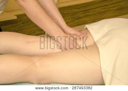 Hands Masseur Doing Anti-cellulite Massage On The Legs Of A Young Girl