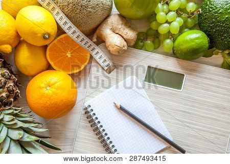 Flat Lay Composition With Scales, Healthy Vegetables And Fruit On Wooden Background. Weight Loss Die