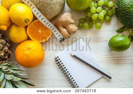 Flat Lay Composition Withmeasuring Tape, Healthy Vegetables And Fruit On Wooden Background. Weight L