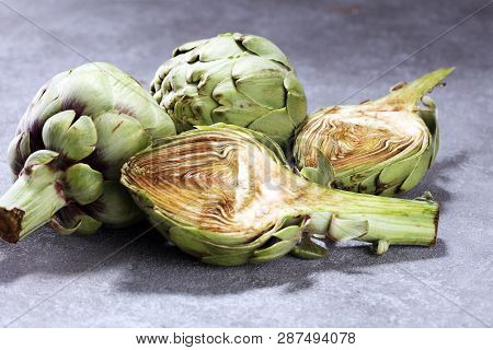 Artichokes On Rustic Background. Fresh Organic Artichoke Flower Set