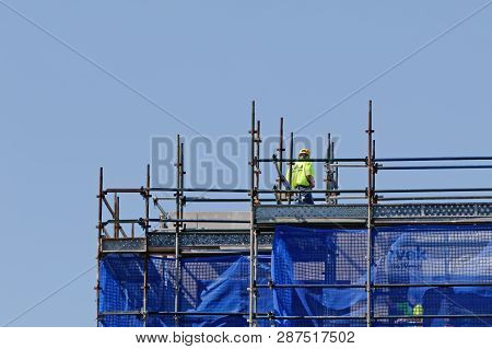 Gosford, New South Wales, Australia - December 3, 2018: Rigger Wearing A Hard Hat Working On Top Flo