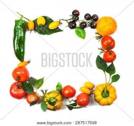 Assorted tomatoes and vegetables isolated on white background. Photo for your design