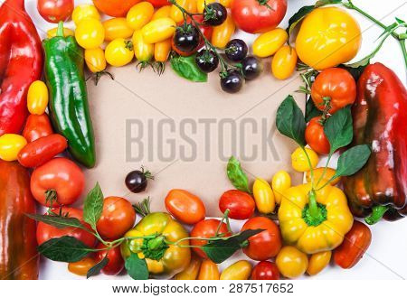 Assorted tomatoes and vegetables isolated on white background. Photo for your design