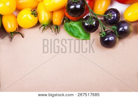 Assorted tomatoes and vegetables isolated on white background. Photo for your design