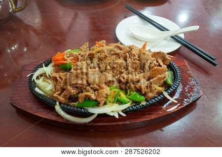 Meat Stir-fry With Red And Green Chili On Wooden Board. Asian Cuisine Meal