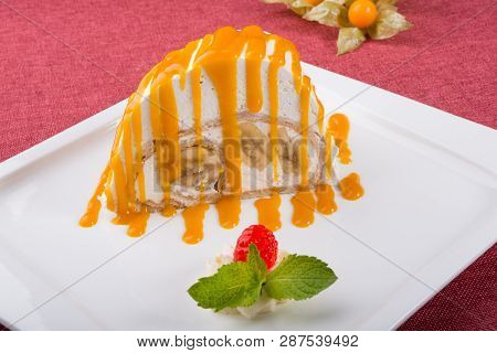 White Spoonge Peice Of Cake With Yellow Syrup