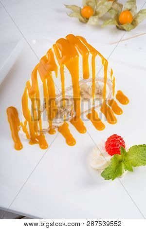 White Spoonge Peice Of Cake With Yellow Syrup