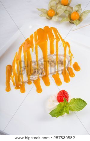 White Spoonge Peice Of Cake With Yellow Syrup