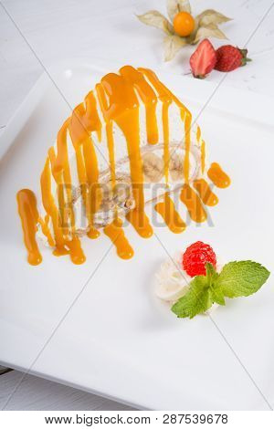White Spoonge Peice Of Cake With Yellow Syrup