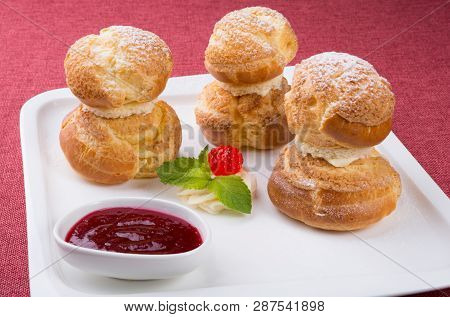 Baked French Desserts Suffed With Cream And Served With Jam
