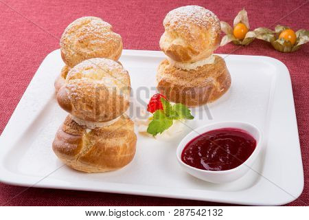 Baked French Desserts Suffed With Cream And Served With Jam