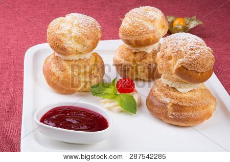 Baked French Desserts Suffed With Cream And Served With Jam