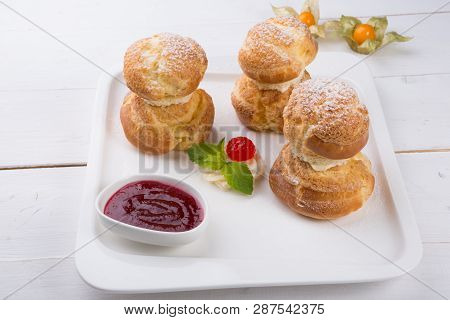 Baked French Desserts Suffed With Cream And Served With Jam