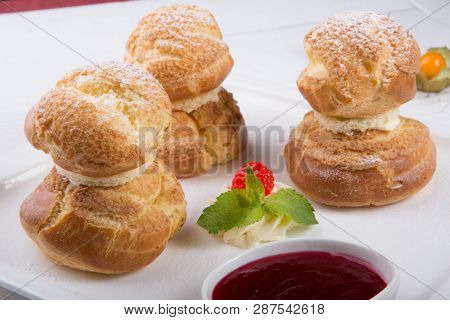 Baked French Desserts Suffed With Cream And Served With Jam