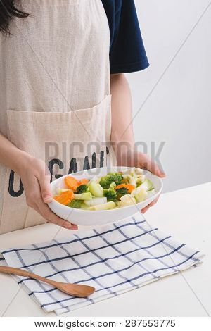 Fresh Vetgetables,carrots,long Beans, Boiled Corn In Hand On White Table