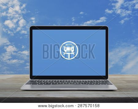 Service Fix Car With Wrench Tool Flat Icon On Modern Laptop Computer On Wooden Table Over Blue Sky W